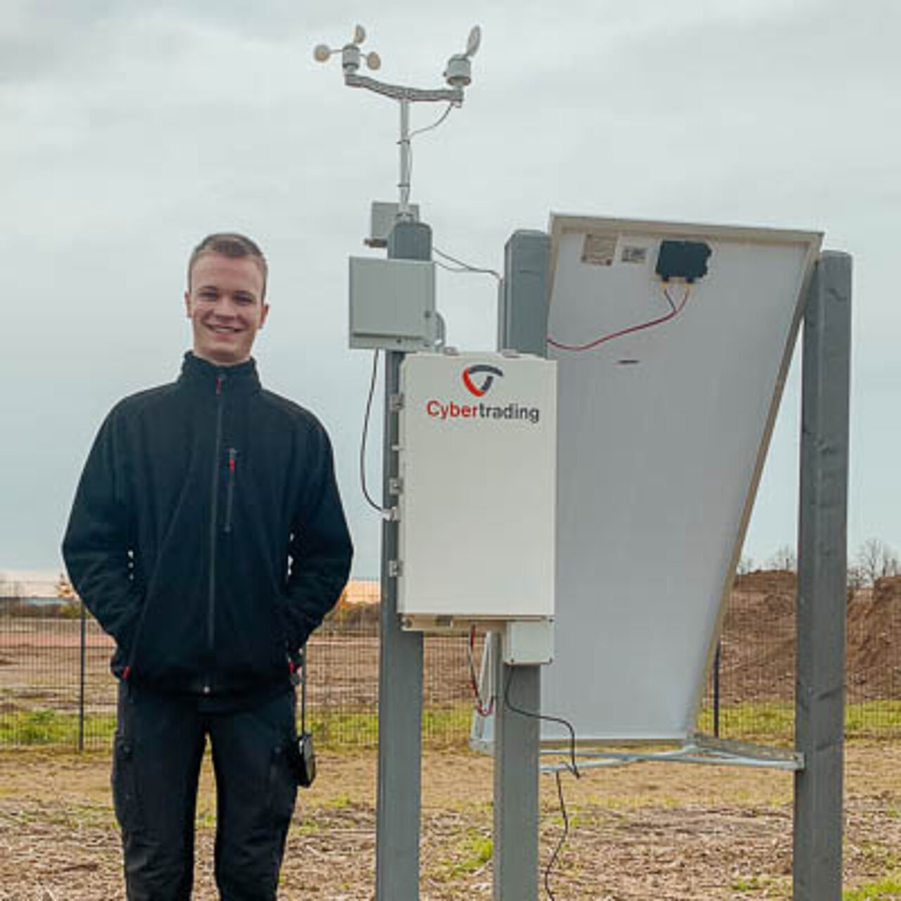 Trainee standing next to weather station