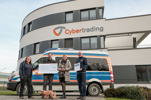 Cybertrading CEO with Head of Marketing handing over a donation check to the coordination and volunteer of Wünschwagens Sachsen-Anhalt