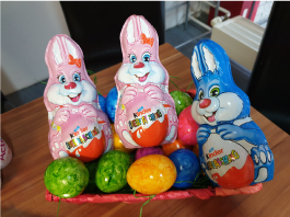 Three chocolate Easter bunnies on an Easter basket