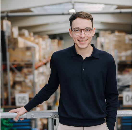 Employee standing at a railing