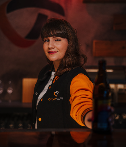 Employee standing at the counter looking over her shoulder