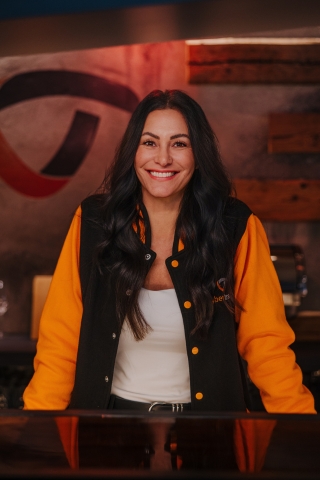 Employee standing at the counter looking ahead